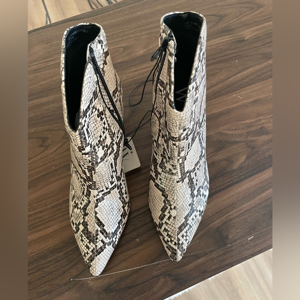 Boots with snakeskin design. Brand new with tags.